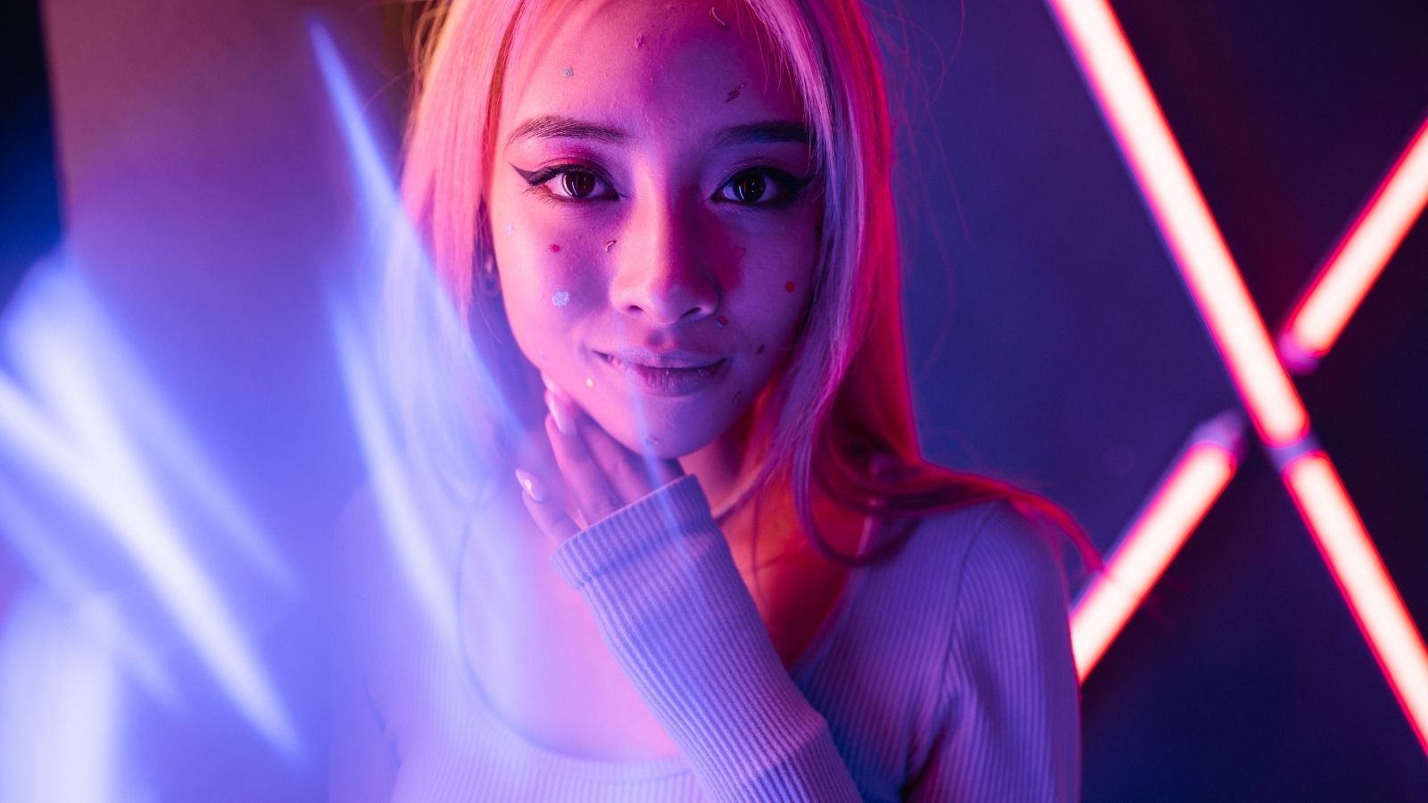 Photorealistic AI girl with flowing hair against a purple and blue neon background, cyberpunk aesthetic, high-fidelity digital art.